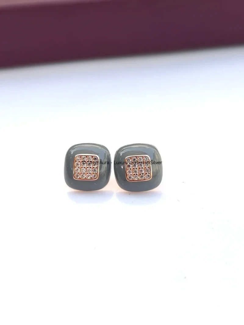 Charcoal stud earrings with rose gold polish