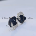 Navy enamel swirl stud earrings, close-up view