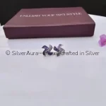 Amethyst swirl studs, close-up view