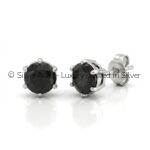 Black solitaire silver studs, close-up view