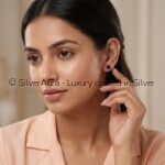 Black solitaire silver studs worn on ear