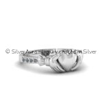 Heart and hands silver ring, close-up view